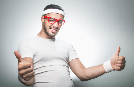 Excited workout man with red glasses giving thumbs up